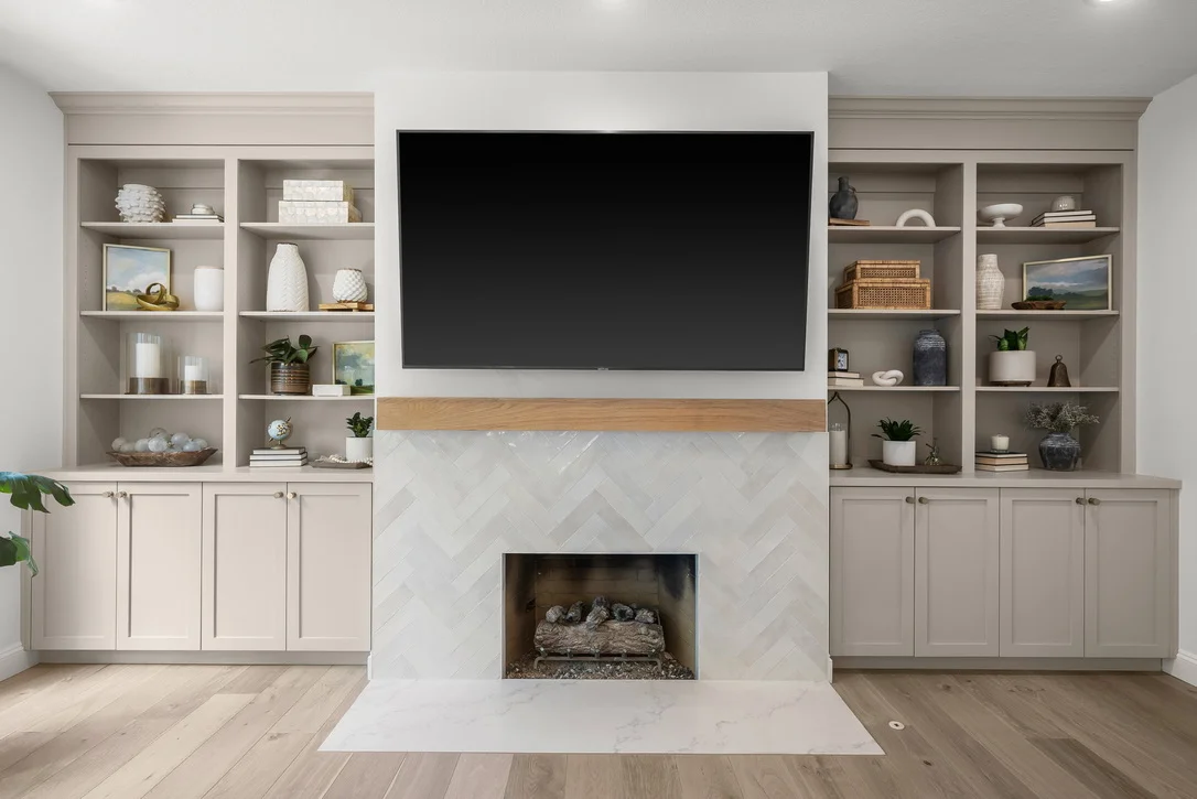 White built-in cabinetry and shelving surrounding a fireplace